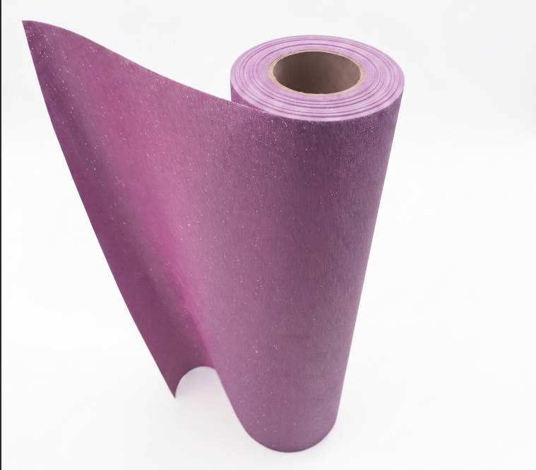 A roll of premium pink glitter DTF transfer film showing fine sparkling shimmer texture for custom apparel heat press printing.