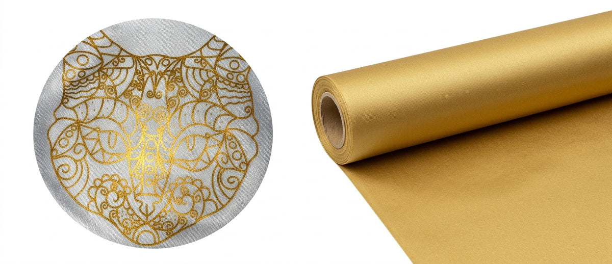 Metallic gold foil DTF transfer film roll alongside a fabric sample printed with an intricate gold ornate cat design to showcase fine-line metallic transfer quality.
